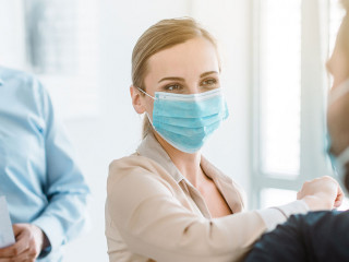 Business people doing corona bump to greet each other in meeting