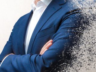 smiling businessman dissolving in the air