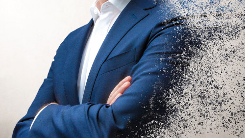 smiling businessman dissolving in the air