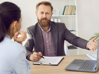 Male manager provides advice to female client and acquaints her with terms of contract.