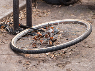 Locked bicycle wheel at bike parking