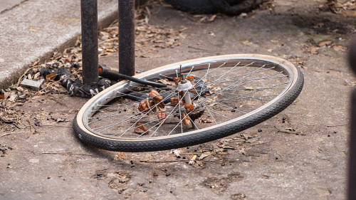 Locked bicycle wheel at bike parking