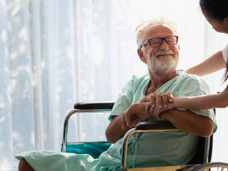 Eldery in wheelchair with nurse. An old man in a hospital, a nur