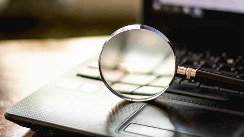 Magnifying glass is located on the keyboard. Of computer noteboo