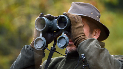 hunter looking through binoculars