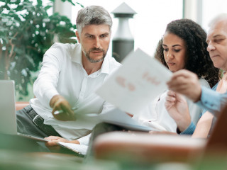 group of businessmen discussing the terms of a new project .