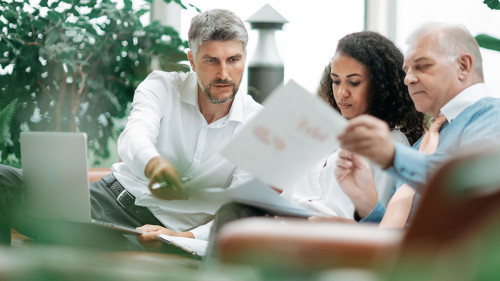 group of businessmen discussing the terms of a new project .