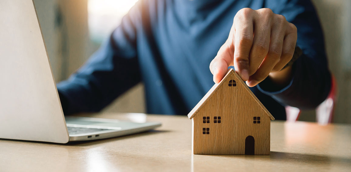 Business hand holding home with Buy or Rent, copy space. Propert