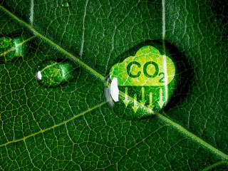 CO2 reducing icon on green leaf with water droplet for decrease