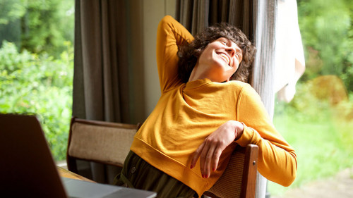 woman relaxing at home looking out of window