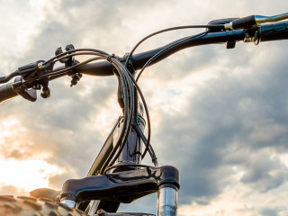 A Bicycle with thick wheels against a beautiful sky.