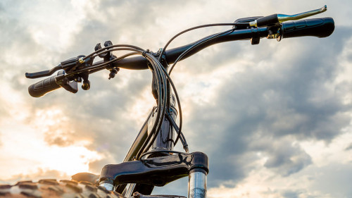 A Bicycle with thick wheels against a beautiful sky.