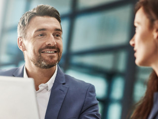 Tablet, teamwork and business people meeting in office workplace. Collaboration, technology and man, woman or employees with touchscreen planning sales strategy or researching finance plan in company