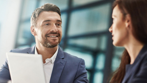 Tablet, teamwork and business people meeting in office workplace. Collaboration, technology and man, woman or employees with touchscreen planning sales strategy or researching finance plan in company