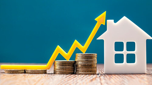 Real estate market, graph, up arrow. House model and a stack of coins. The concept of inflation, economic growth, the price of insurance services