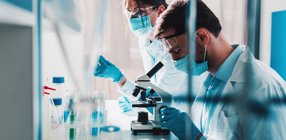 Doctor in the laboratory analyzes samples of codiv-9 under a microscope