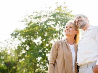 Senior Caucasian couple hugging in park. Family with a happy smi
