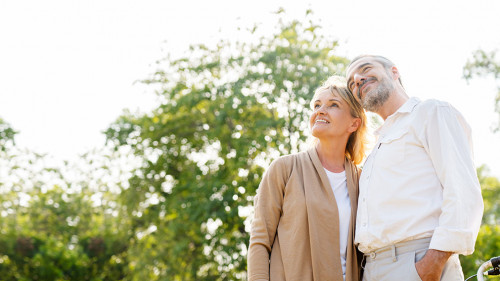 Senior Caucasian couple hugging in park. Family with a happy smi