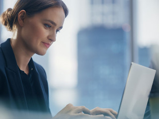 Close Up Portrait of a Successful Businesswoman Working on Lapto