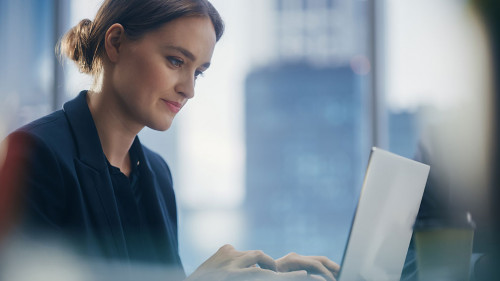 Close Up Portrait of a Successful Businesswoman Working on Lapto