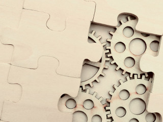 wooden gears under the puzzle, the concept of moving to the next