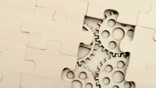 wooden gears under the puzzle, the concept of moving to the next