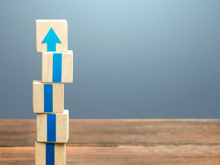 Block tower with blue arrows. Growth, development progress. Road map agreement concept. Career promotion step by step. Education, learning. Reaching a new level. Improving skills. Raising the standard