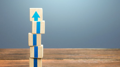 Block tower with blue arrows. Growth, development progress. Road map agreement concept. Career promotion step by step. Education, learning. Reaching a new level. Improving skills. Raising the standard