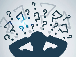 Silhouette of stressed businessman, question marks