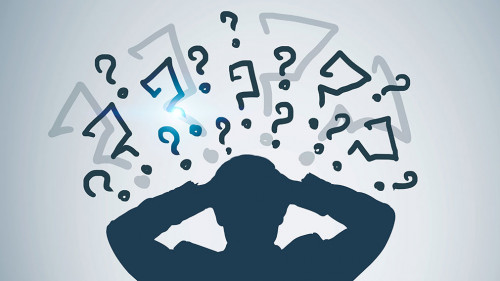 Silhouette of stressed businessman, question marks