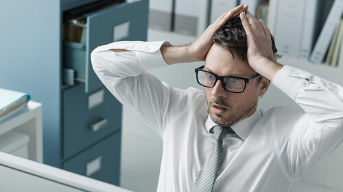 Panicking businessman receiving bad news