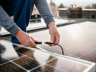 Worker installing solar energy panels. Alternative energy system. eco concept