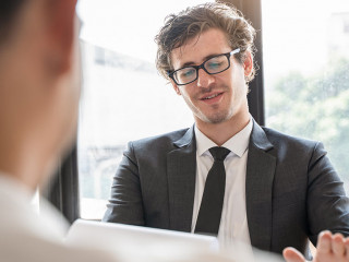 interviewer on the table asking question applicant in the office