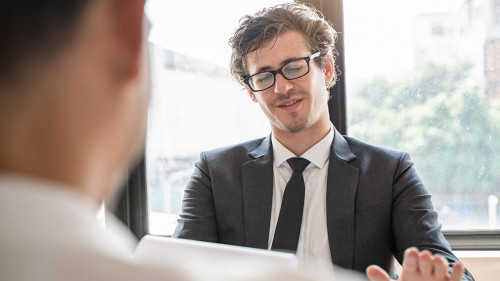 interviewer on the table asking question applicant in the office