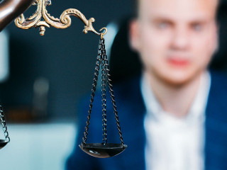 scales of justice. a young man is a lawyer, a judge, a prosecuto