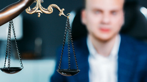 scales of justice. a young man is a lawyer, a judge, a prosecuto