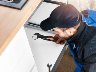 Plumber fixing sink in bathroom. Repair leaking water concept