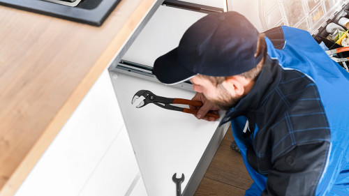 Plumber fixing sink in bathroom. Repair leaking water concept