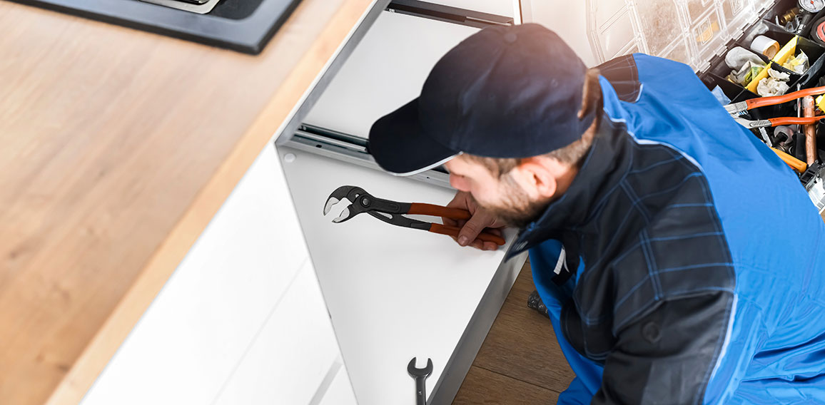 Plumber fixing sink in bathroom. Repair leaking water concept