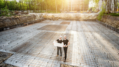 Builders with drawings at the construction site