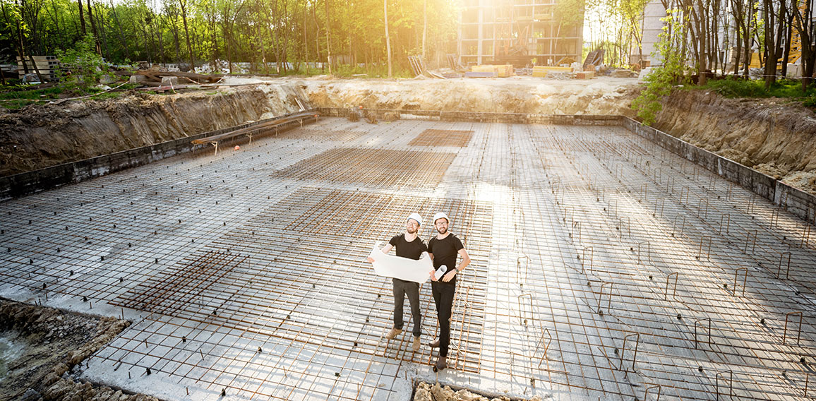 Builders with drawings at the construction site