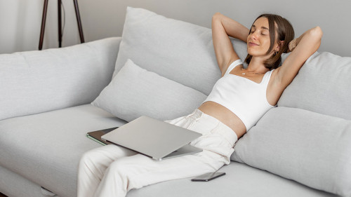 Woman with a laptop on the couch at home