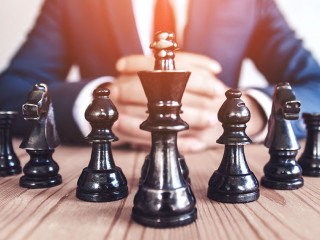 Retro style image of a businessman with clasped hands planning s