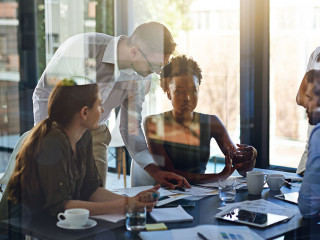 They give their all at work. Shot of a group of businesspeople having a meeting in a boardroom.