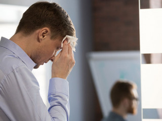 Nervous sweaty speaker preparing speech wiping wet forehead with