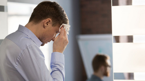 Nervous sweaty speaker preparing speech wiping wet forehead with