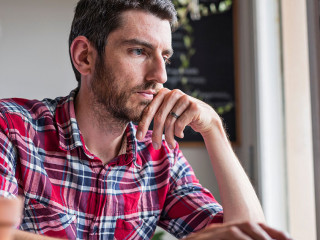 Man using laptop on desk working from home