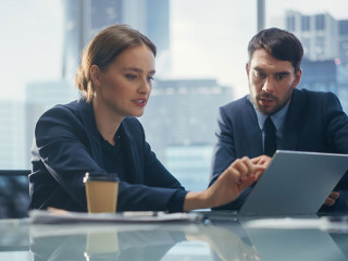 Successful Corporate CEO and Investment Manager Talking, Using L