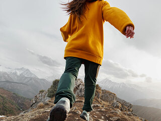 Sporty girl runs high in mountains