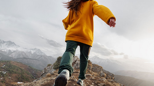 Sporty girl runs high in mountains